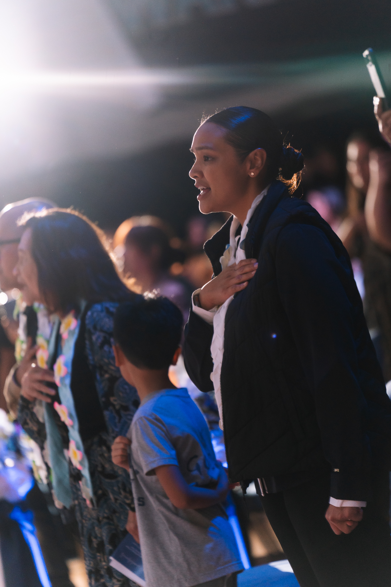 Saint Paul community standing for the pledge at a school ceremony